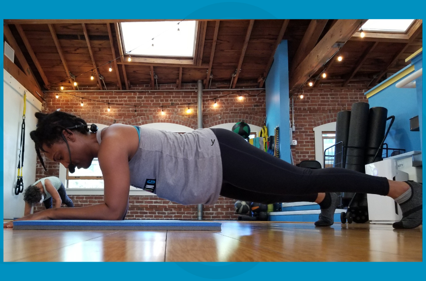 Tyler holding a strong forearm plank pose with aligned spine